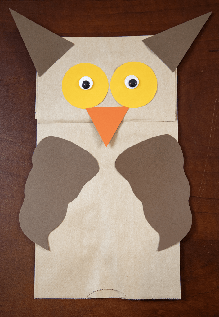 Paper bag puppet owl with googly eyes art.