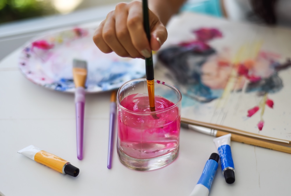 Young artists practicing fun painting techniques.