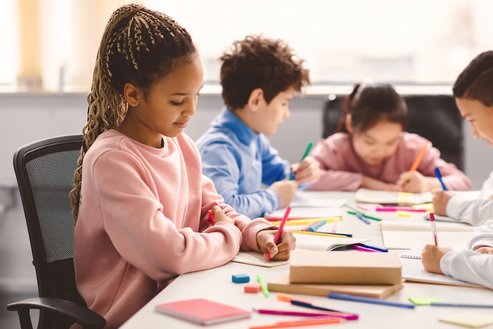 Elementary children concentrating while drawing.