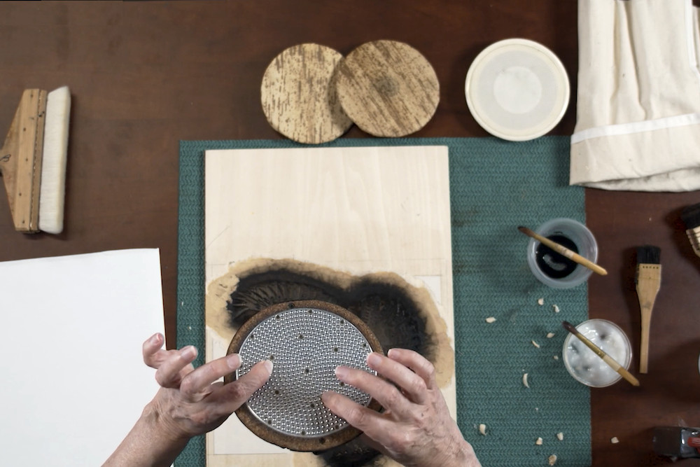 A baren on paper during mokuhanga printing.
