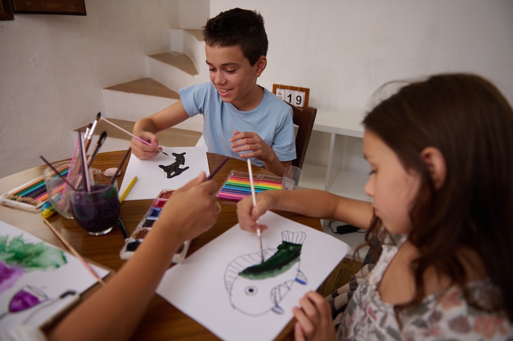 Young children engaged in process art activities.